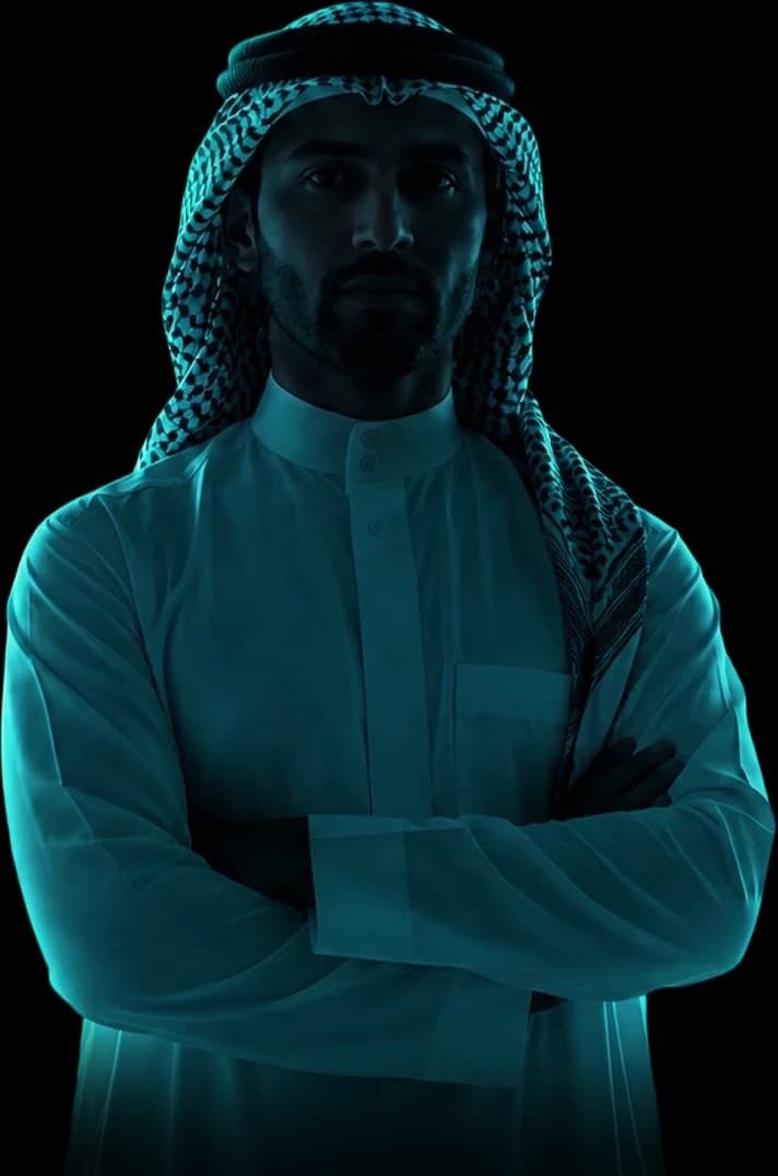 A man in traditional Saudi dress standing before the Riyadh skyline